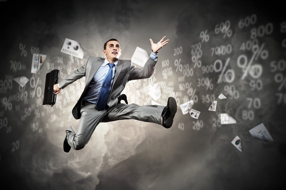 Image of a businessman jumping high against financial background